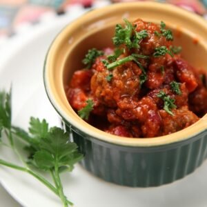 Close-up of a flavorful homemade chili dish garnished with fresh parsley, perfect for a cozy meal.