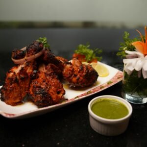 Spicy tandoori chicken served with refreshing green chutney and garnish.