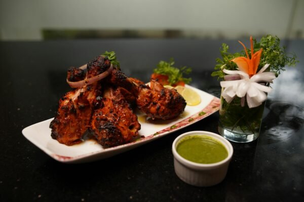 Spicy tandoori chicken served with refreshing green chutney and garnish.