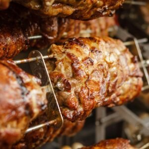 Close-up of juicy and perfectly grilled rotisserie pork, ideal for barbecue lovers.