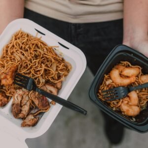 Delicious Asian takeout noodles with shrimp and chicken presented in takeout boxes, ready to eat.