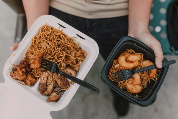 Delicious Asian takeout noodles with shrimp and chicken presented in takeout boxes, ready to eat.